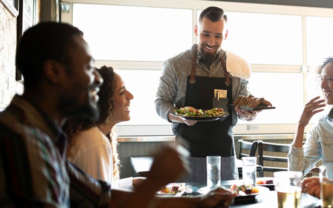 people enjoying friends and a meal at a restaurant