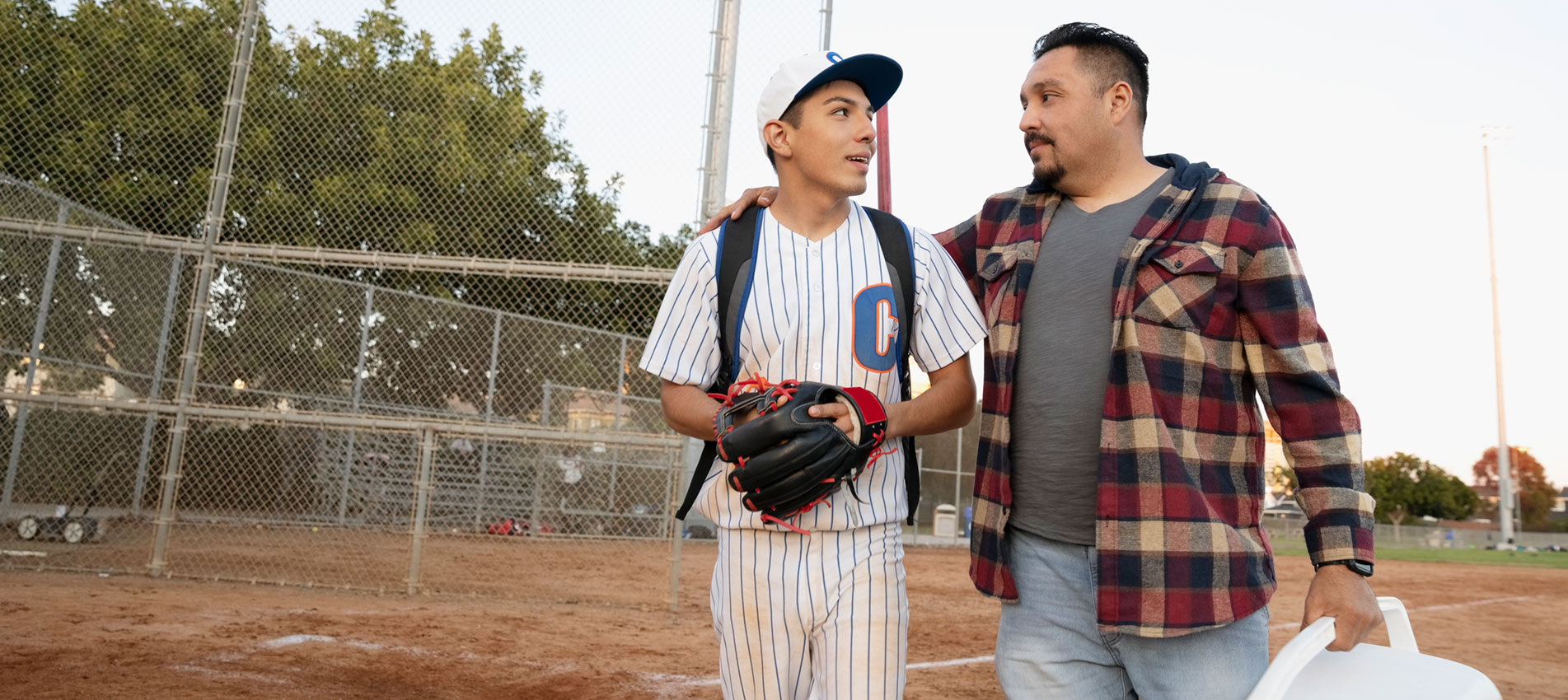 Father And Baseball Player Son Walking Off Field