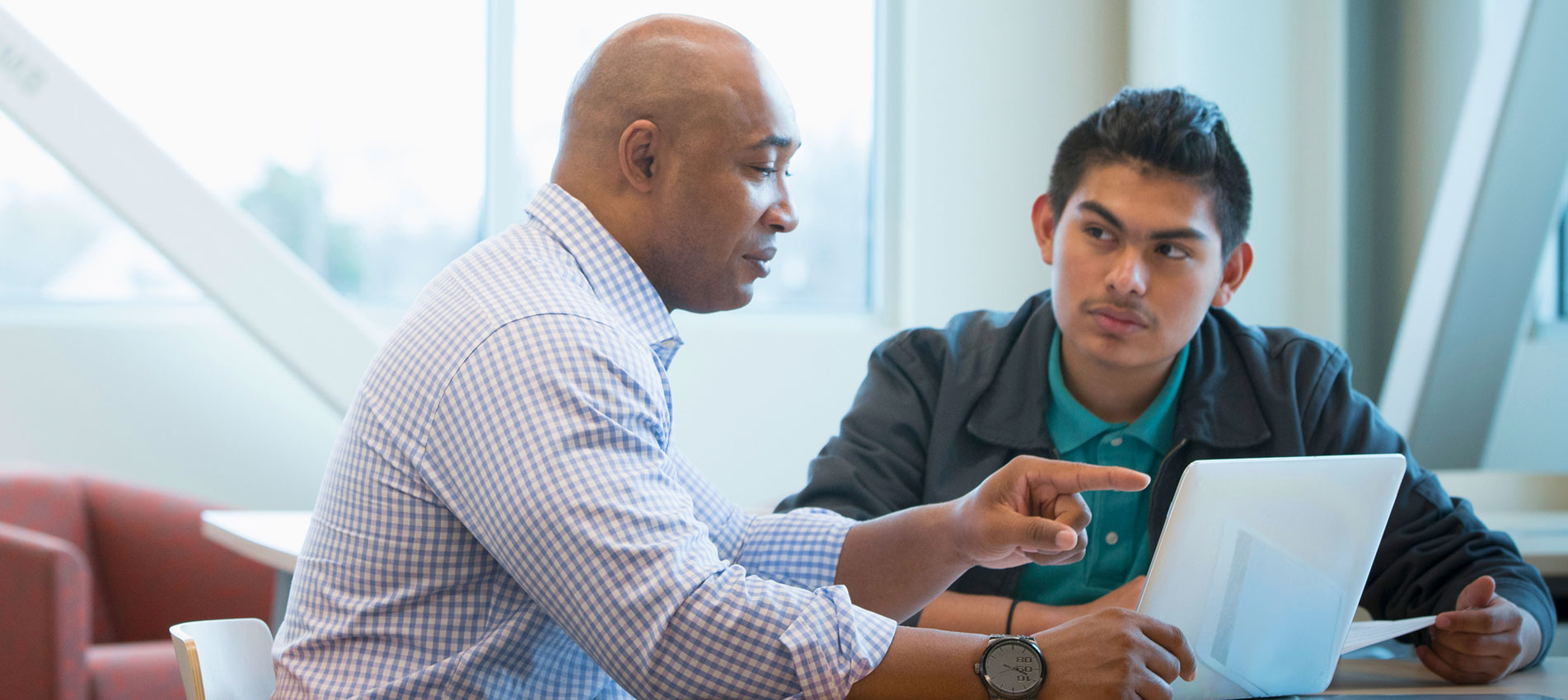 Mentor Helping Student Use Laptop