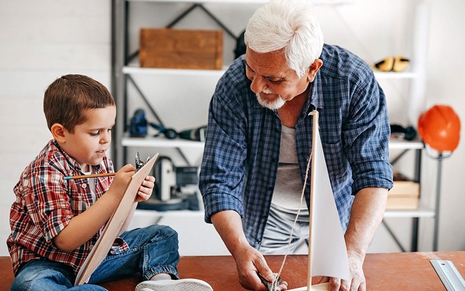 Grandfather And Grandson Making Ship At Home