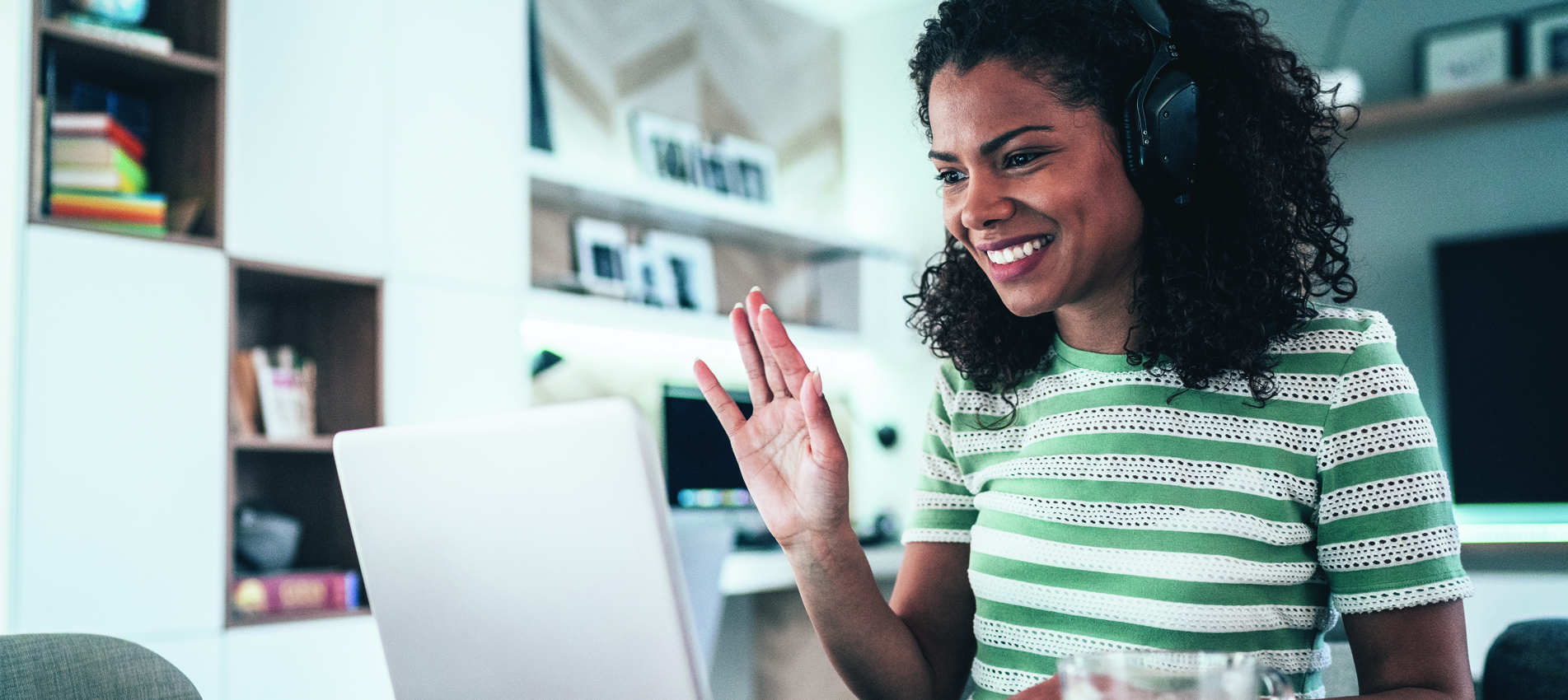 Young female employee working online at home smiling