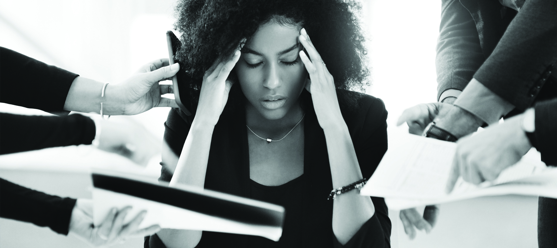 Young female employee working at the office stressed out with work requests