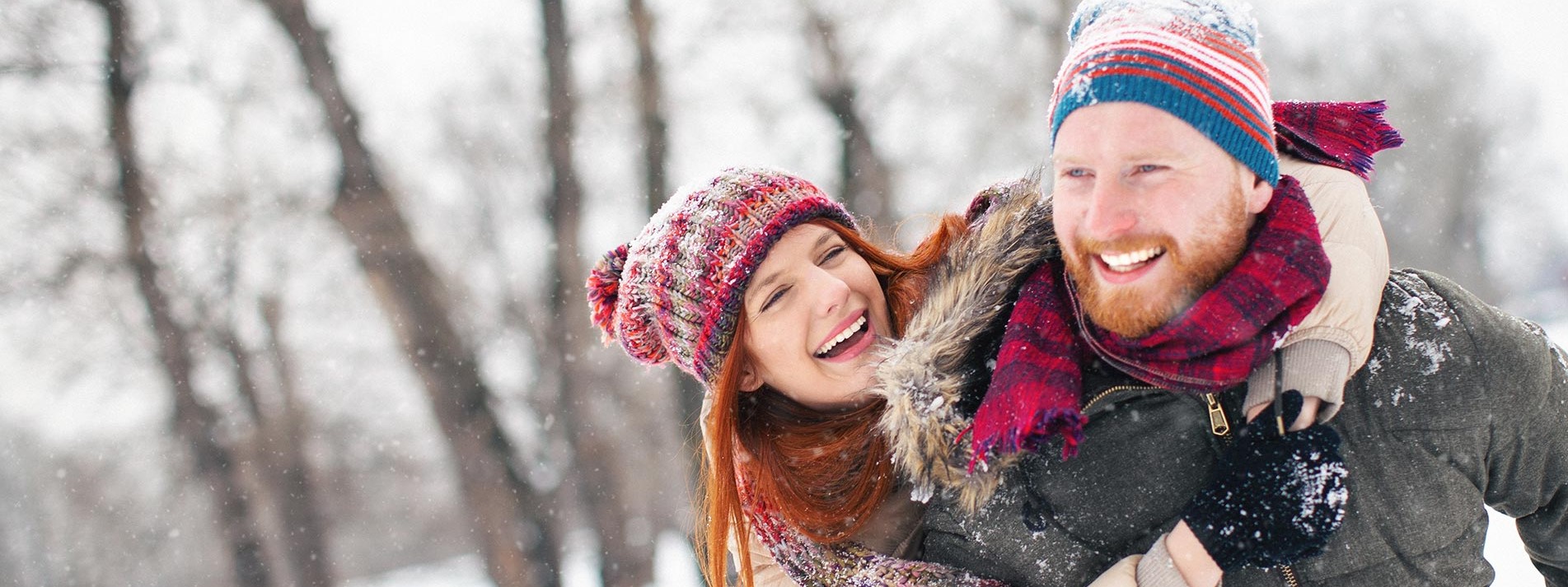 Young Couple Having Fun In The Snow