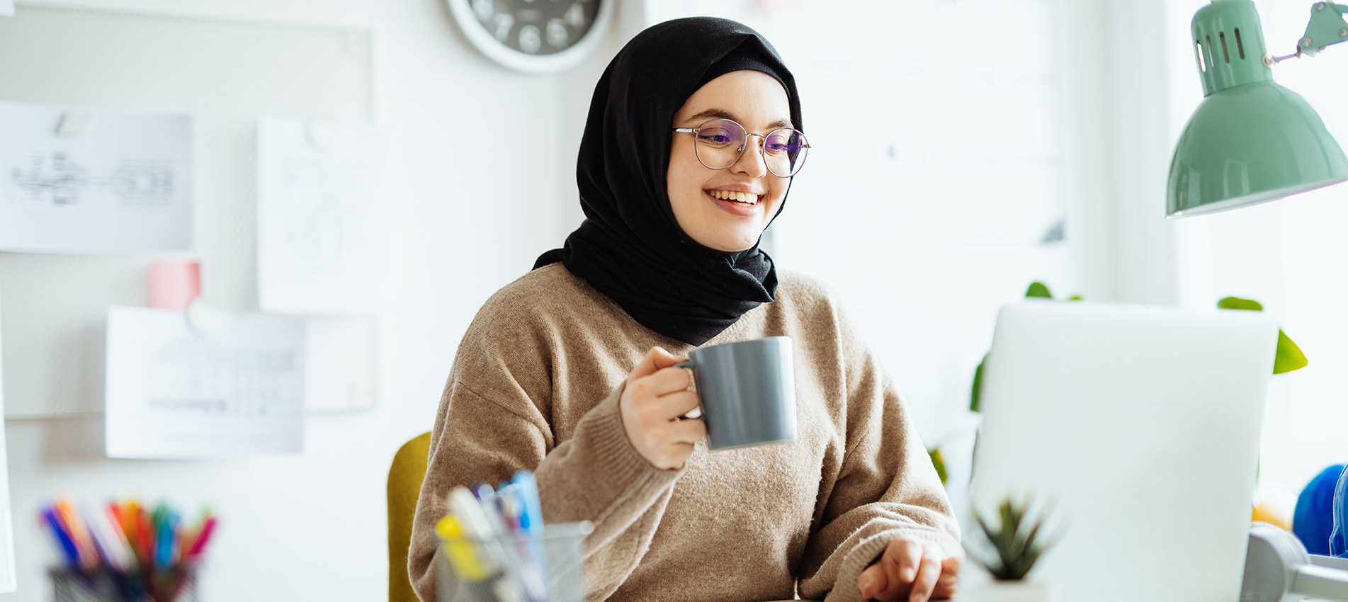 Middle Eastern Woman With Hijab And Glasses Working On Laptop
