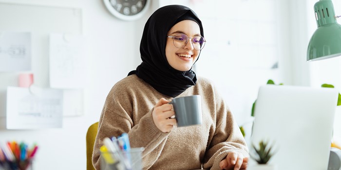 Middle Eastern Woman With Hijab And Glasses Working On Laptop