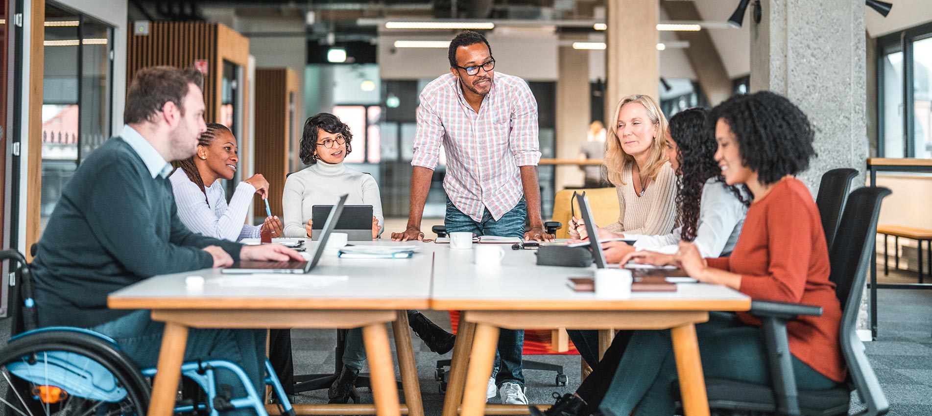 Group Of Diverse People Including A Man On A Wheelchair Are Working Together