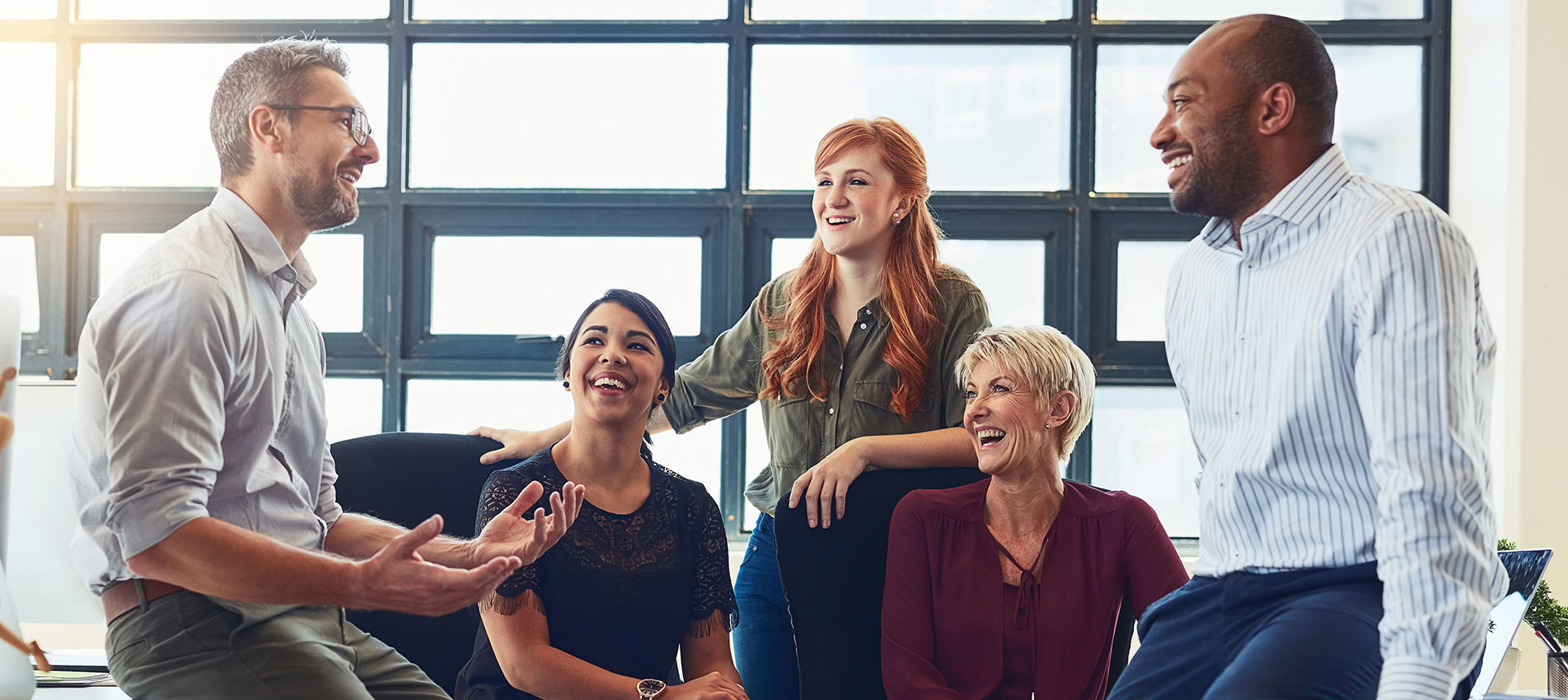 Diverse Group Of Colleague Having A Discussion In An Office