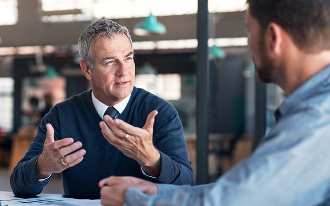 Businessmen Having Discussion In Office