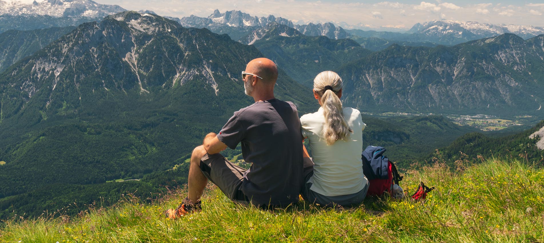 Couple Taking A Break During Hiking High Up In The Mountains