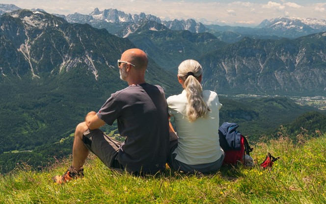 Couple Taking A Break During Hiking High Up In The Mountains