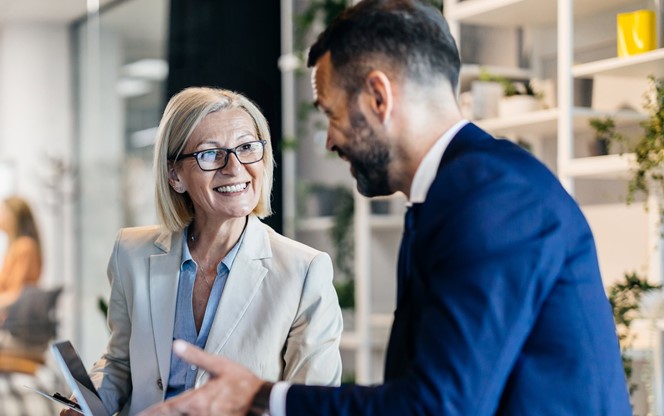Senior Businesswoman And Male Colleague Discussing Ai Technology