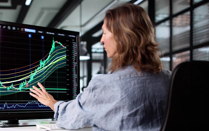 Businesswoman Analyzing Stock Market Trends On Screen