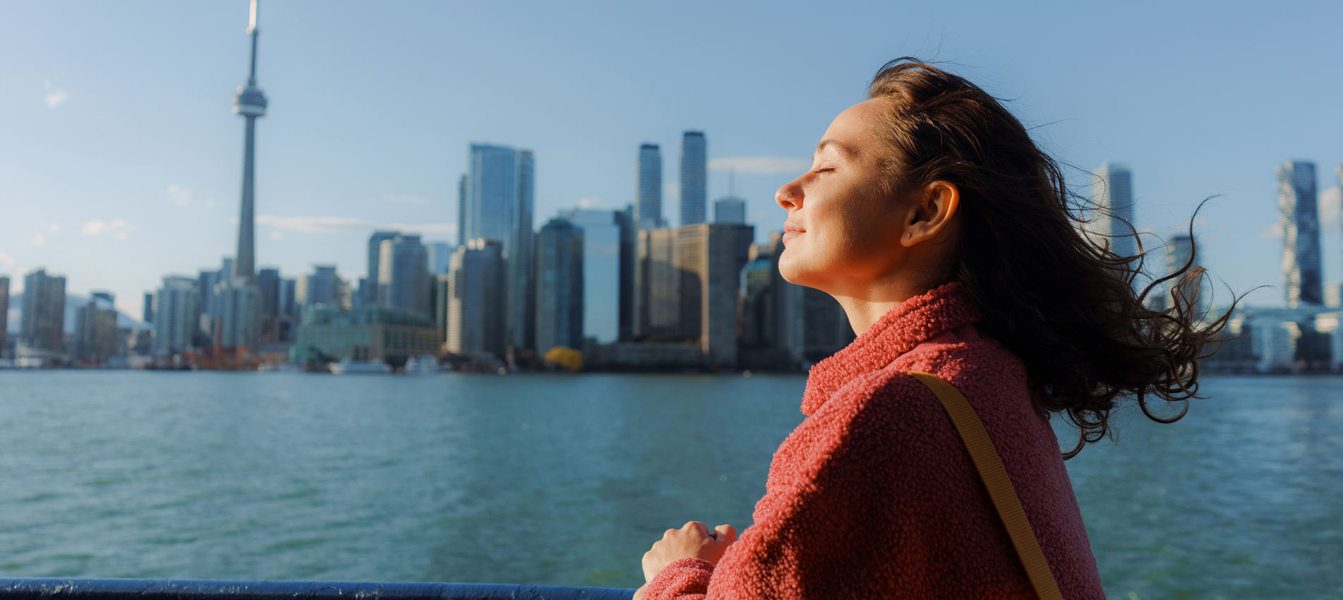 Woman Looking At Cityscape From Ferry To Toronto Island